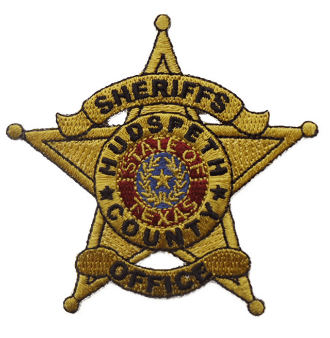A close-up of a sheriff's badge

Description automatically generated