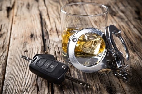Alcohol, car keys, and handcuffs
